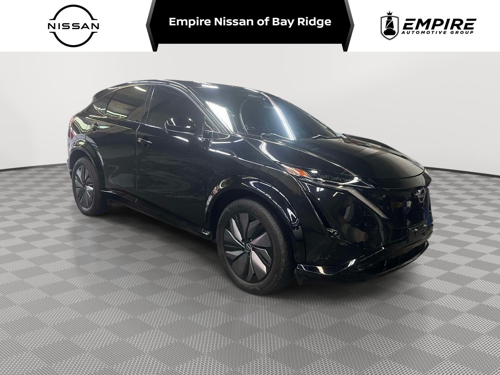 2023 Nissan ARIYA ENGAGE in Black Diamond Pearl — front three-quarter view