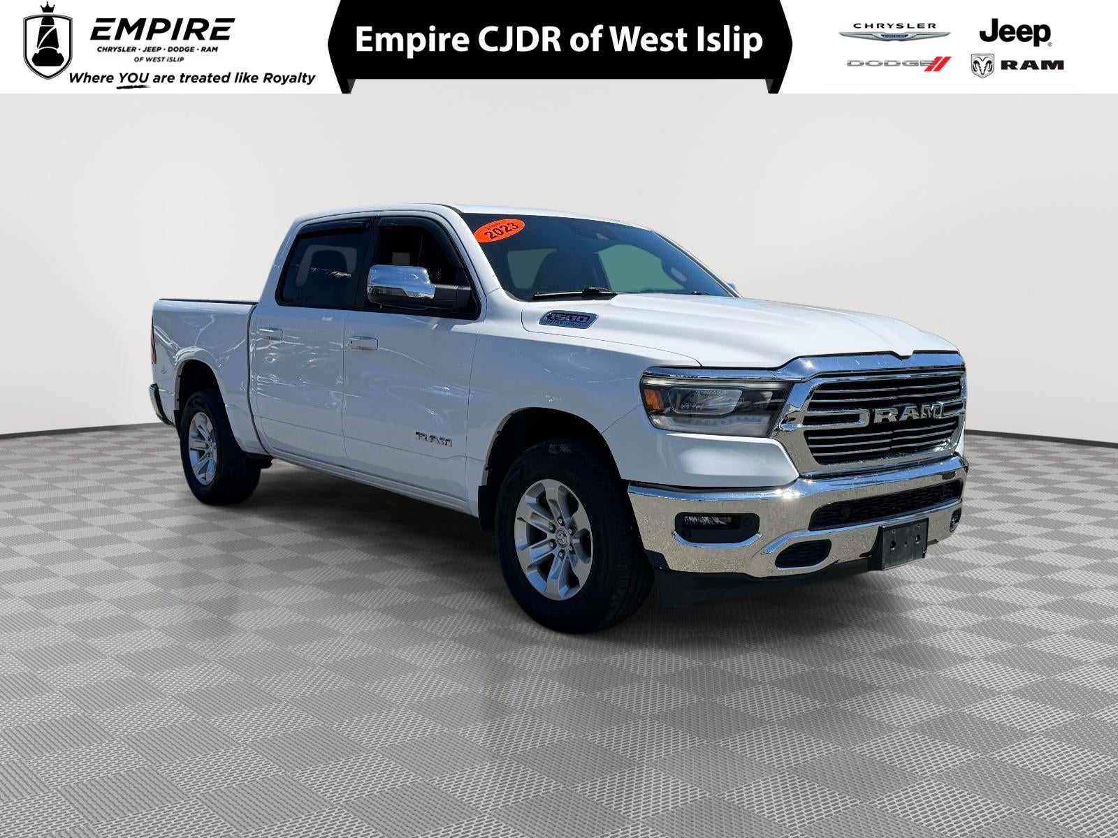 2023 RAM 1500 Laramie Crew Cab 4x4 5'7' Box in Bright White Clearcoat — front three-quarter view